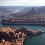 Not only is Lake Powell's water level plummeting because of drought, its total capacity is shrinking, too